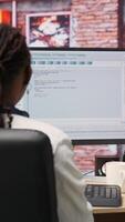Vertical Software developer at PC coding, creating software, implementing algorithms. IT expert in home office working with code editor, building applications, optimizing performance, camera B panning shot video