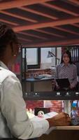 Vertical Woman at home answering videocall from manager checking tasks progress, showing documents, presenting progress done. Teleworker in videoconference with team leader, talking about paperwork, camera A video