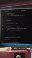 Vertical Computer desk with coding application on monitor used for creating software, implementing algorithms. Code editor on PC display used to build applications in cozy bright living room video