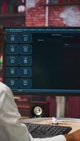 Vertical Woman seated at desk using AI LLM chatbot software in modern urban home office. Person requesting help from large language model program on computer in bright apartment workspace, camera B video