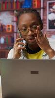 Vertical Manager in home office arguing with employee during phone call, looking at laptop. Team leader scolding worker during telephone call after finding errors in documents, camera B video