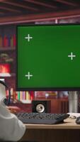 Vertical Teleworker at home using isolated screen PC display during job shift, analyzing data at desk, compiling reports. Remote worker doing tasks on chroma key computer, typing information, camera B video