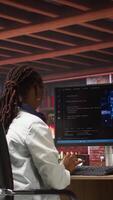Vertical Teleworking programmer using computer for artificial intelligence computing through self learning algorithms. Remote worker working with AI deep neural networks on desktop PC, camera A wide angle shot video