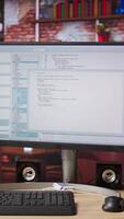 Vertical Programming code executing software UI on computer monitor in apartment office. Close up of coding application on PC screen used to write and test code in modern apartment, jib down shot video