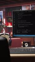 Vertical Coding interface shown on computer screen on desk in bright home office. Command lines written in code editor program UI on PC display in modern cozy home living room workspace video
