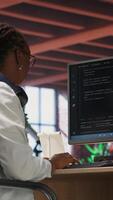 Vertical Teleworking programmer using computer for artificial intelligence computing through self learning algorithms. Remote worker working with AI deep neural networks on desktop PC, camera B video