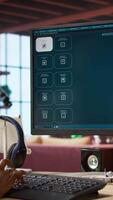 Vertical Woman in apartment workspace using AI software turning text prompt into photos and listening music. Person in brick wall home wearing headphones uses text to image generative models on PC, camera A video
