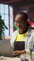 Vertical Worker at home starting job shift, opening laptop to analyze data at desk, compiling analytical reports. Remote employee beginning tasks, using notebook device, writing down information, camera A video