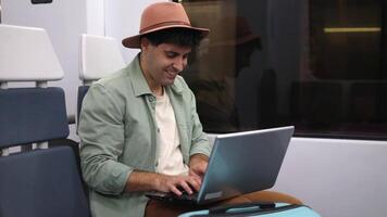 Digital nomad working on laptop while traveling by train video