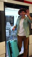 vertical traveler waving at camera while getting off train, happy to reunite after long journey video