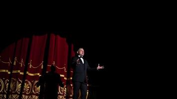 Kyiv, Ukraine, 2 May 2024 Senior man in costume on stage in darkness. Actor man in selective light on stage during the performance in the theater. video