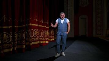 Kyiv, Ukraine, 29 May 2024 Man in suit speaking jokes in microphone standing on stage. Funny performance. Comedian in good humor speaks to the audience. video