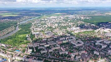 Cityscape under blue clouds. Beautiful view on the city surrounded by nature. Aerial view. Camera rising up. video