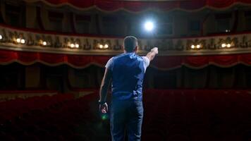 Kyiv, Ukraine, 29 May 2024 Middle age male entertainer, presenter or actor on stage. Public speaker gives performance in front of empty auditorium. Man in theater. video