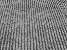 a black and white photo of a road with a car on it