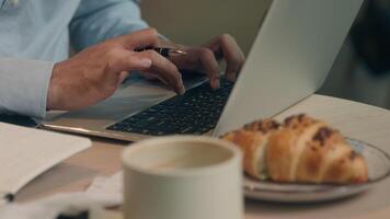 Cropped shot hands typing laptop keyboard unrecognizable business man guy male businessman at cafe table online work computer browsing internet write tasks count bills freelancer student distant study video