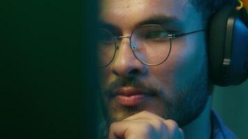 Close up Caucasian man businessman business male guy programmer hacker computer user gamer cyber working laptop web net crypto browsing playing game at home dark evening neon room wearing headphones video