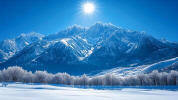 winter landscape with snow covered mountains and sun photo