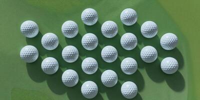 Neatly Arranged Set of Golf Balls Lined Up on a Lush Green Course. photo