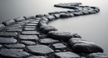 Dark gray cobblestone pathway with textured surface. photo