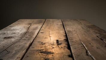 A rustic wooden table with a weathered surface illuminated by soft lighting creating a warm and vintage atmosphere in a dark setting photo
