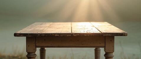 Soft sunlight casts a cozy glow on an old wooden table in a tranquil setting. photo