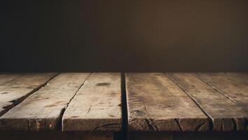 A rustic wooden table with a weathered surface illuminated by soft lighting creating a warm and vintage atmosphere in a dark setting. photo