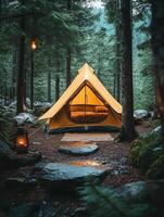 A serene camping scene with a yellow tent nestled among tall trees in a forest. photo