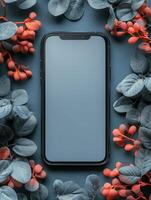 A smartphone surrounded by decorative foliage and berries, showcasing a minimalist aesthetic. photo