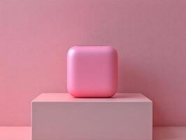A smooth, pink cube-shaped object displayed on a pedestal against a pink background. photo