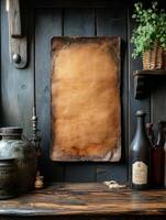 A rustic wooden backdrop displaying a blank parchment, surrounded by vintage items and greenery. photo