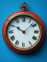 A vintage pocket watch with Roman numerals on a vibrant blue background. photo