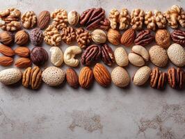 A variety of nuts arranged neatly on a textured surface. photo