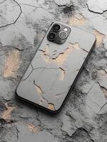 A smartphone with a cracked surface design on a textured background. photo
