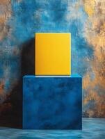 A vibrant yellow box atop a blue pedestal against a textured background. photo