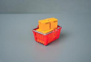 A basket with boxes of goods. Buyer behavior, consumer patterns and preferences. Logistics and supply of retail outlets. photo