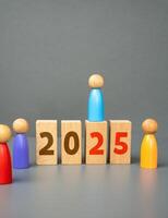 Figures of people and blocks with 2025. New Year. Plans and tasks. Visions and development in the future. photo