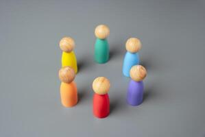 Multi colored figures of people stand in a circle. Cooperation and unity of the LGBT community. Collaboration between members of the new team. Teamwork. photo
