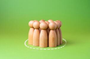 People are gathered in a circle. Assemble a group based on criteria. Find a team. Candidates for recruiting. Not enough space. Isolate from the rest, set apart. photo