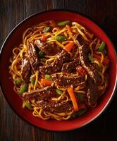 Delicious stir-fry noodles with beef and vegetables in a vibrant bowl photo