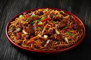 Savory beef lo mein served in a vibrant round dish photo