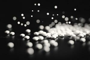 Sprinkling white granules on a dark surface creates a stunning visual effect photo