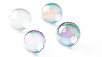 Four iridescent soap bubbles on a white background photo