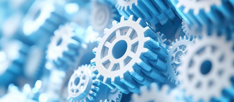 Close-up of White Gears Interlocking Against a Blue Background photo