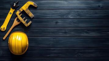 Yellow Construction Tools on Black Woodgrain Background photo