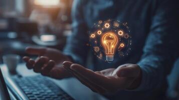 Person Holding a Glowing Light Bulb with Gears Around It photo