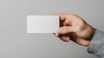Hand Holding a Blank White Card photo