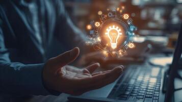 Hand Holding a Lightbulb with Gears and Technology Icons photo