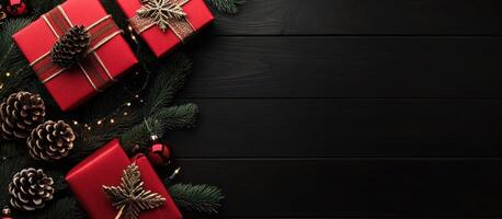Red Christmas Presents with Pine Cones on a Black Wooden Surface photo