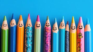 Colorful Pencils with Happy Faces on Blue Background photo